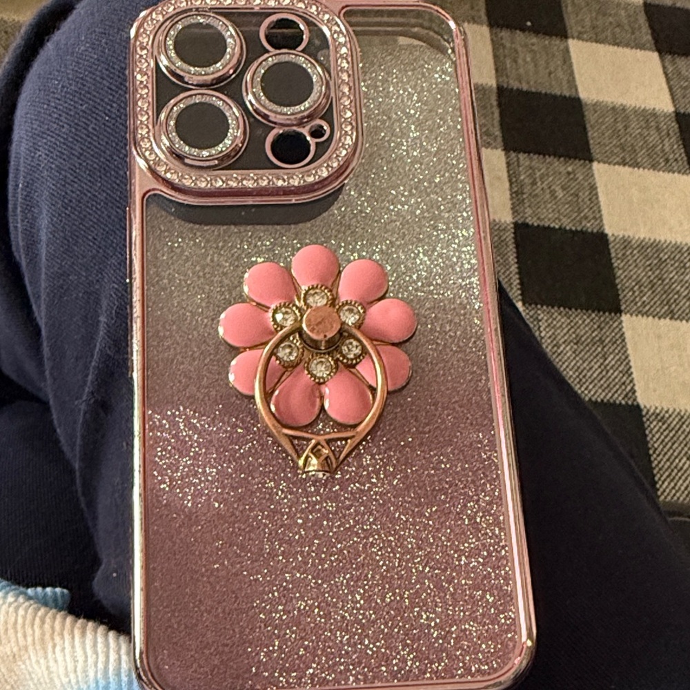 Glitter Pink Phone Case with Floral Design this is for an iPhone 16 pro